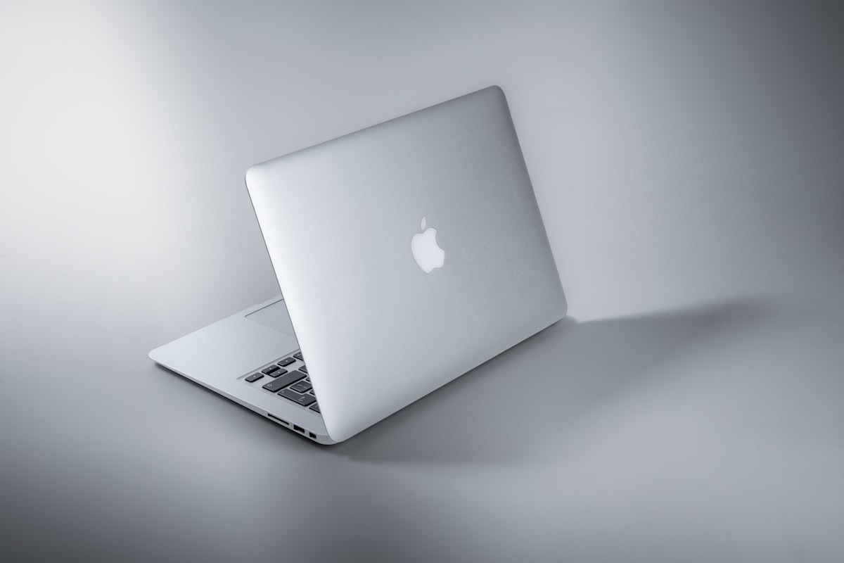 A sleek, modern Mac laptop on a clean desk, showcasing a premium Apple Silicon workspace.